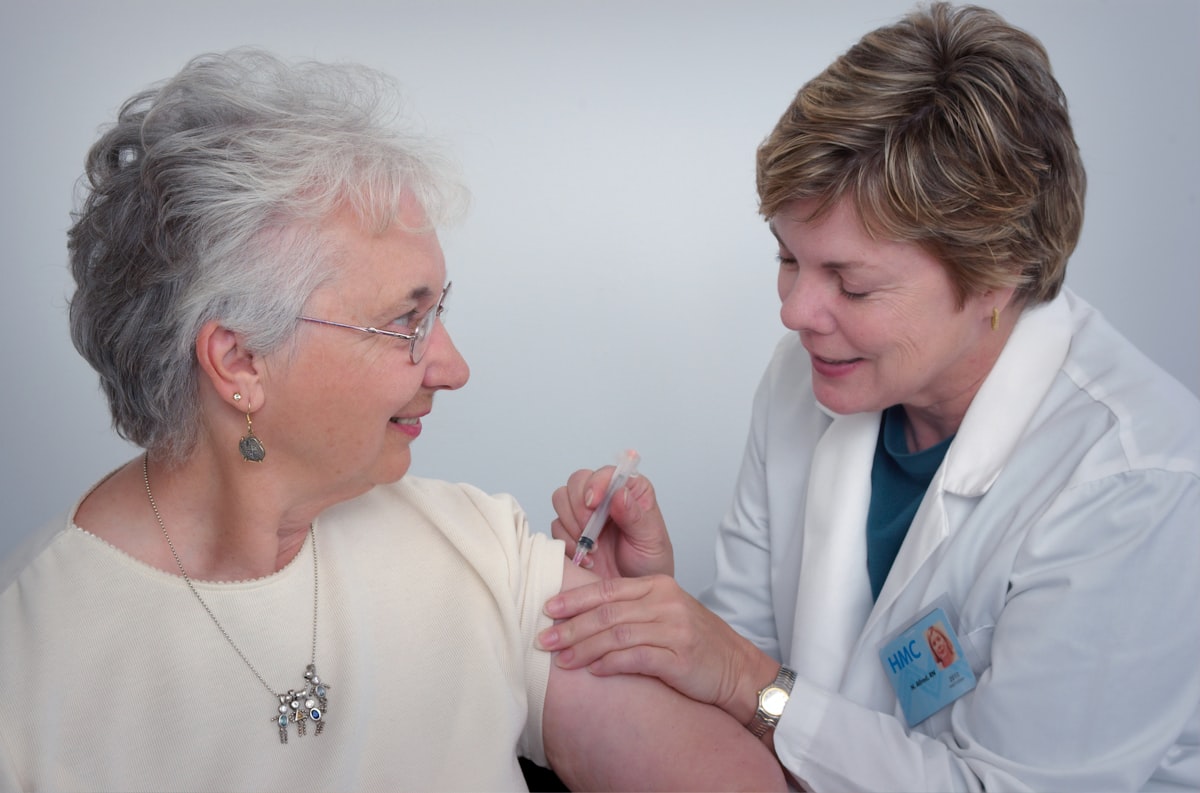 An older patient being cared for by a clinician.