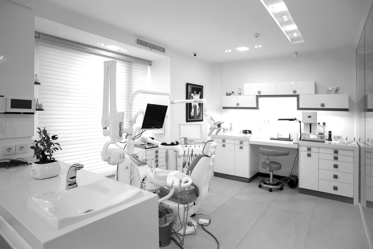 An empty, brightly lit clinical treatment room in the late afternoon.